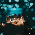 person holding lights in their hand